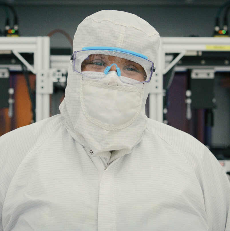 Employee in a cleanroom suit prepares for the precision manufacturing of Magic Leap waveguides for AR glasses.